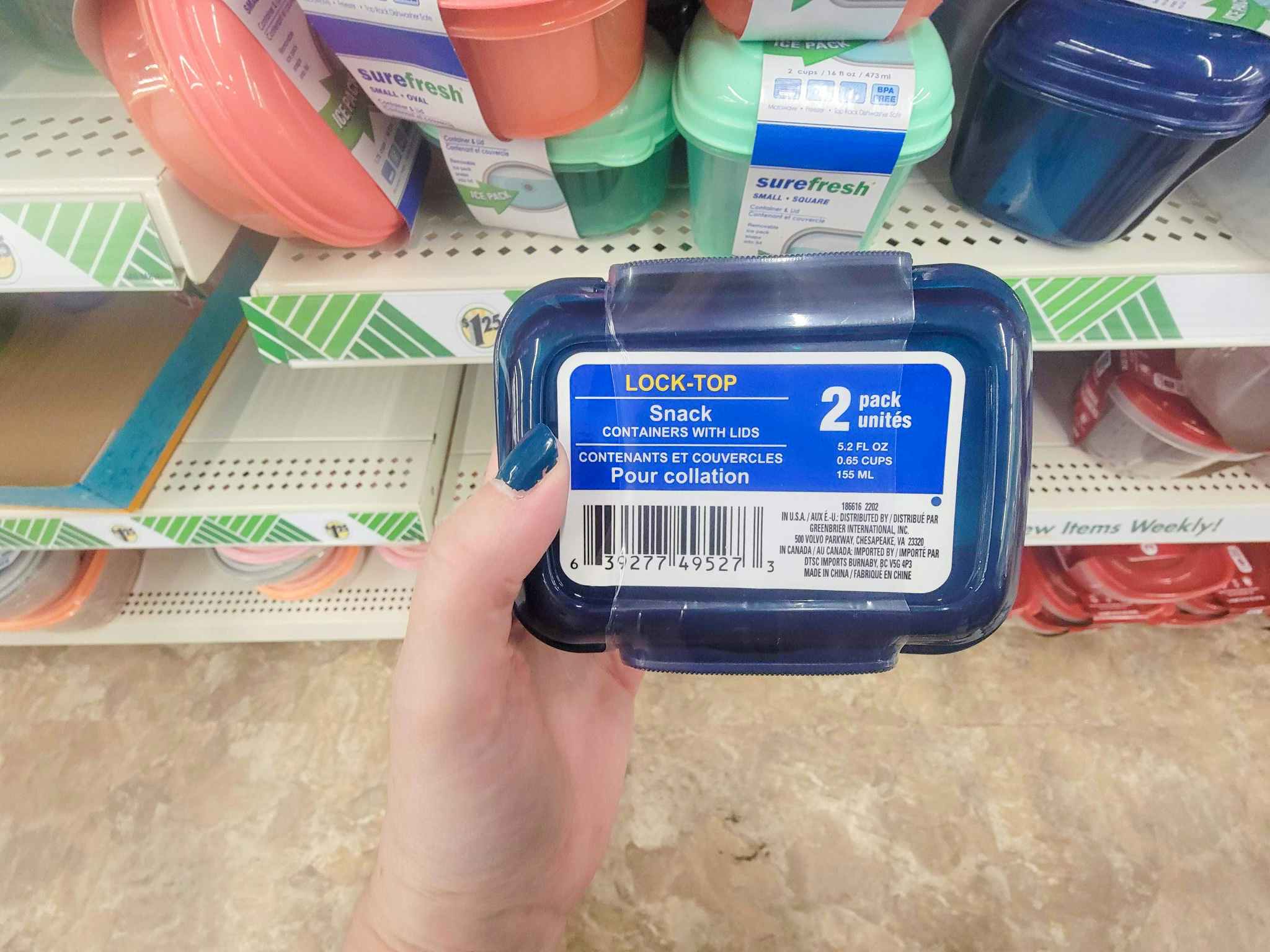 hand holding a pack of snack containers