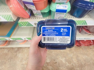 hand holding a pack of snack containers