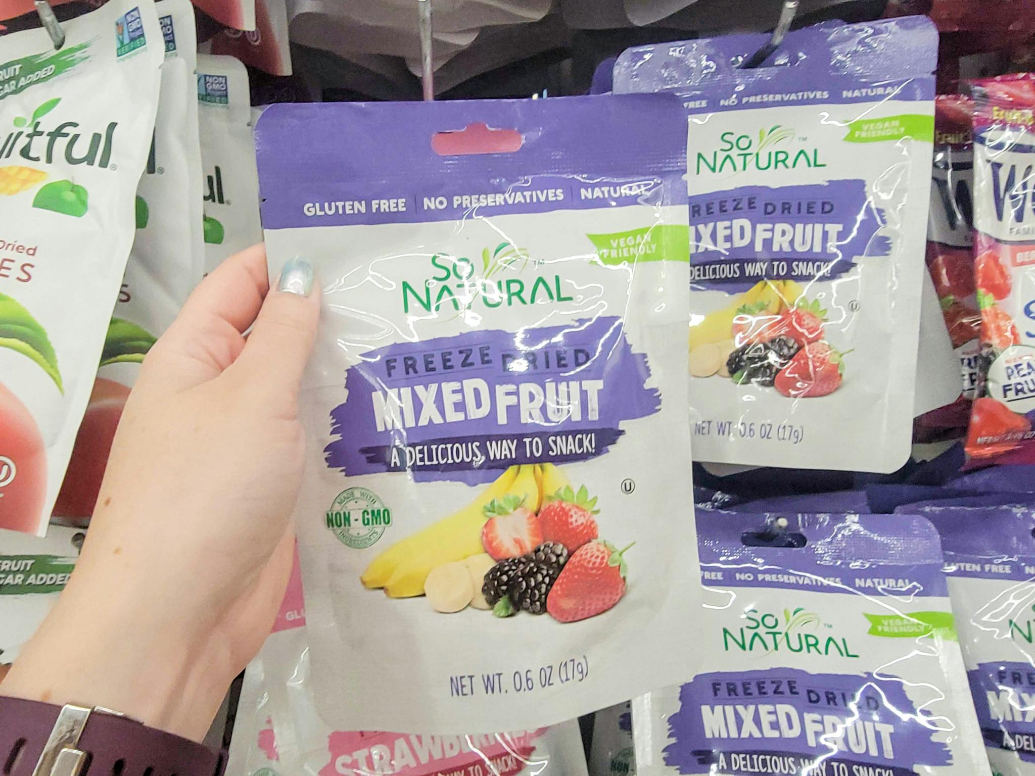 hand holding a bag of freeze dried mixed fruit