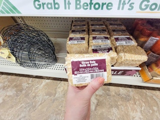 hand holding a straw bale