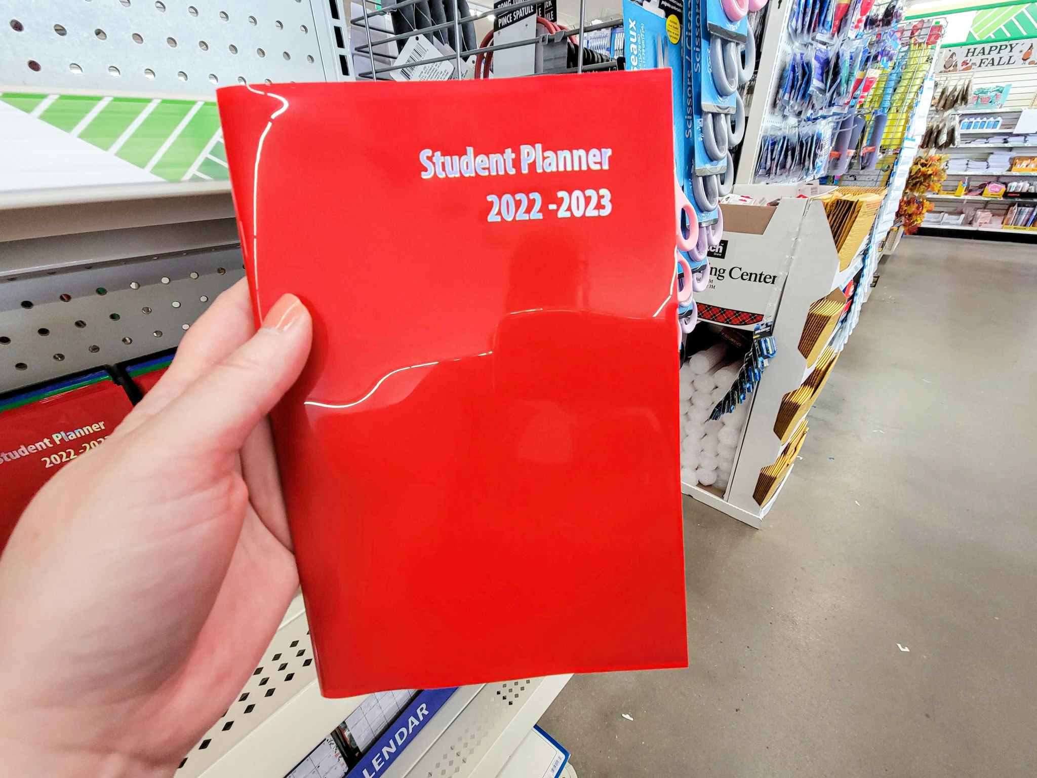 hand holding a red 2023 student planner