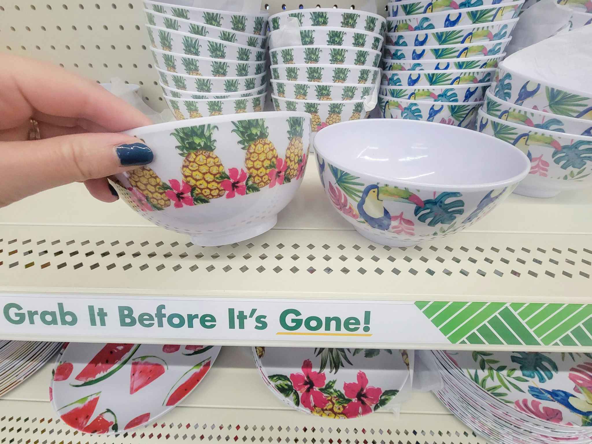 hand holding a bowl with pineapples on it