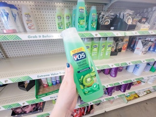 hand holding a bottle of kiwi vo5 shampoo