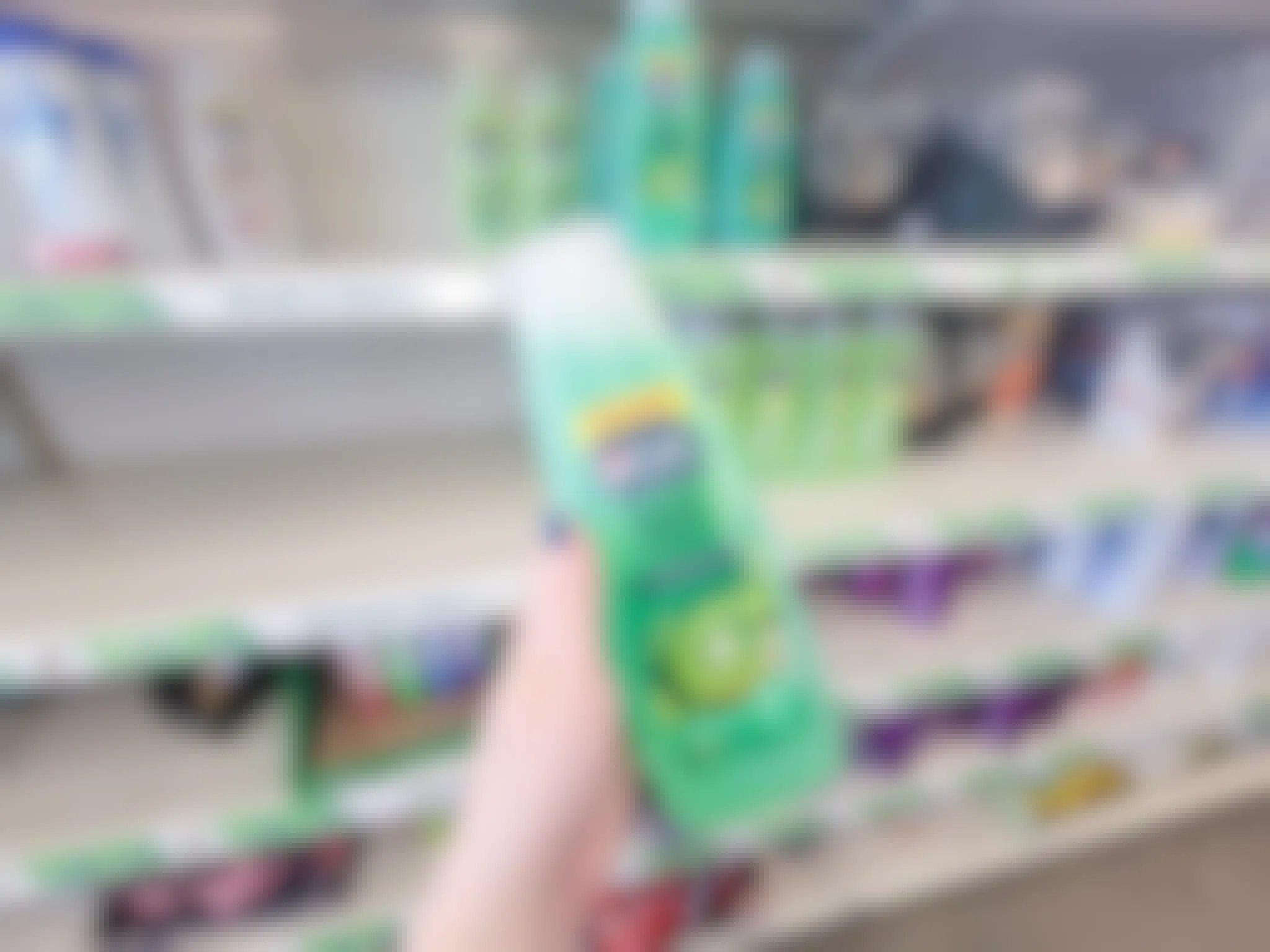 hand holding a bottle of kiwi vo5 shampoo
