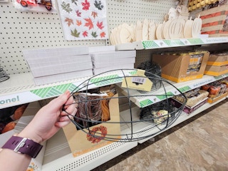 hand holding a football wreath form