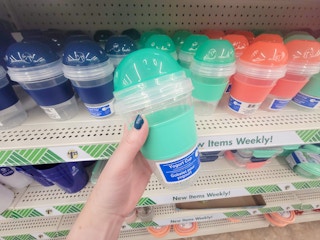 hand holding a yogurt cup lunch container
