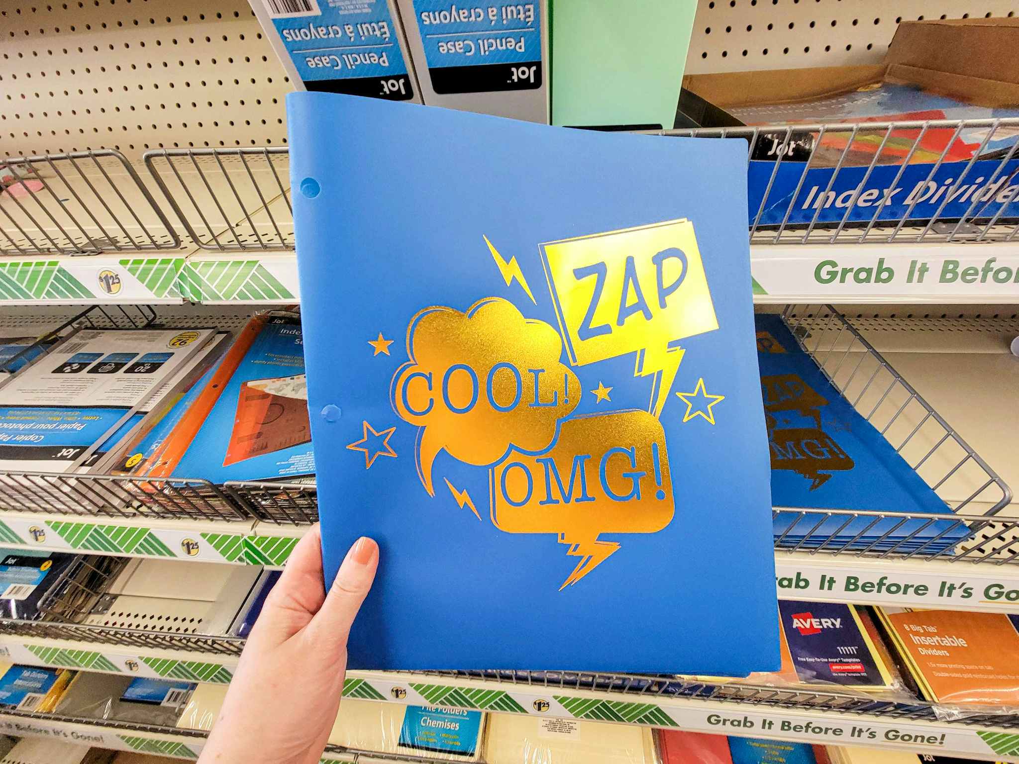 hand holding a blue pocket folder that says zap cool and omg