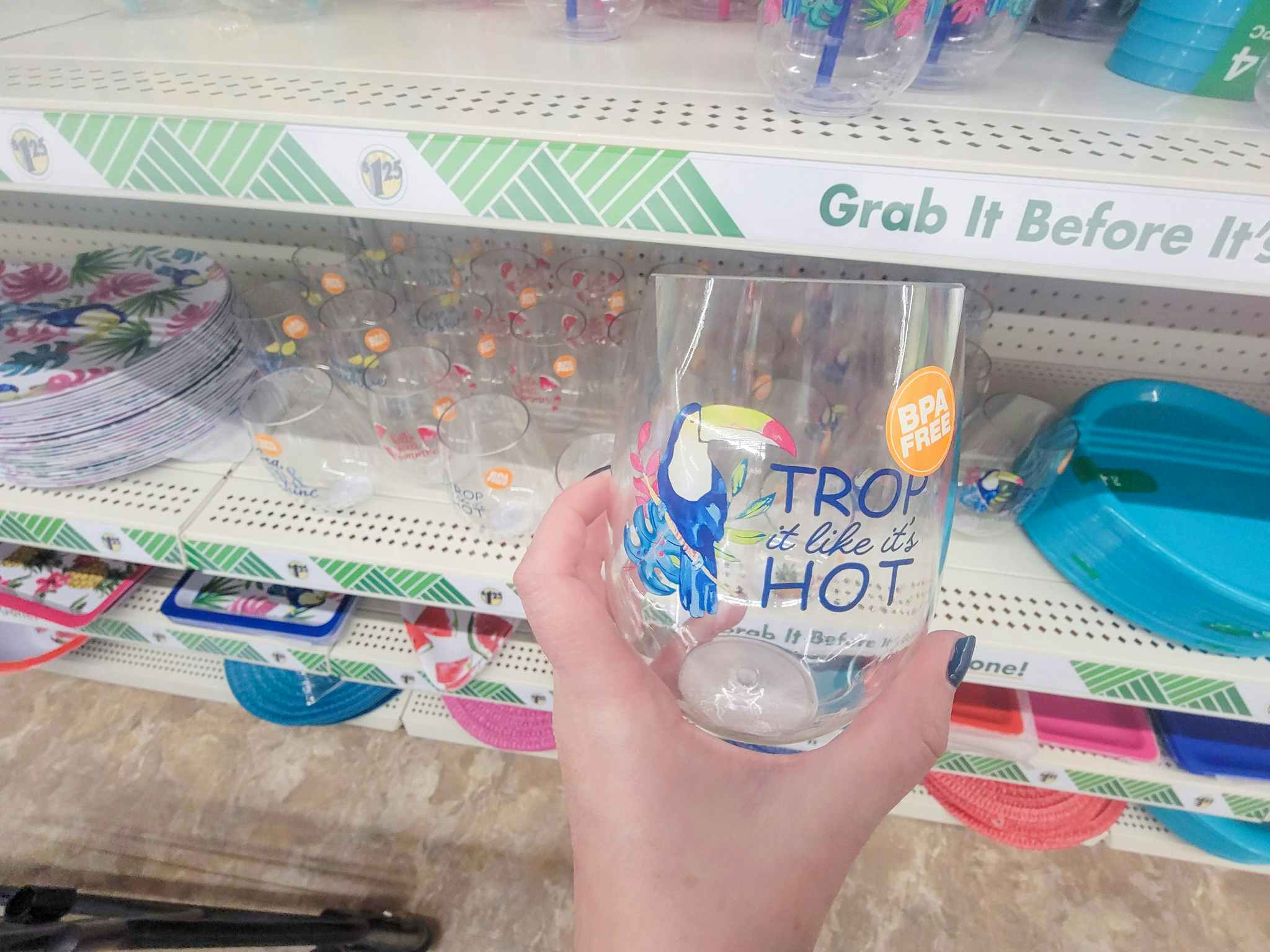 stemless wine glass that says "trop it like it's hot" with a toucan on it