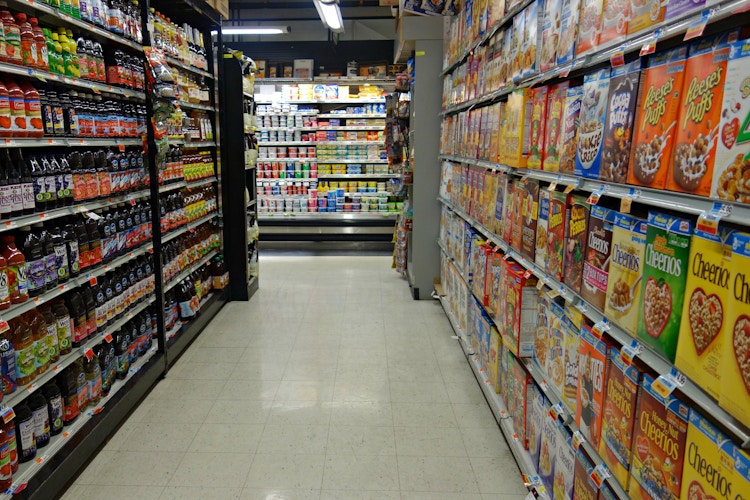a supermarket aisle with no people in it with the lights dimmed after hours