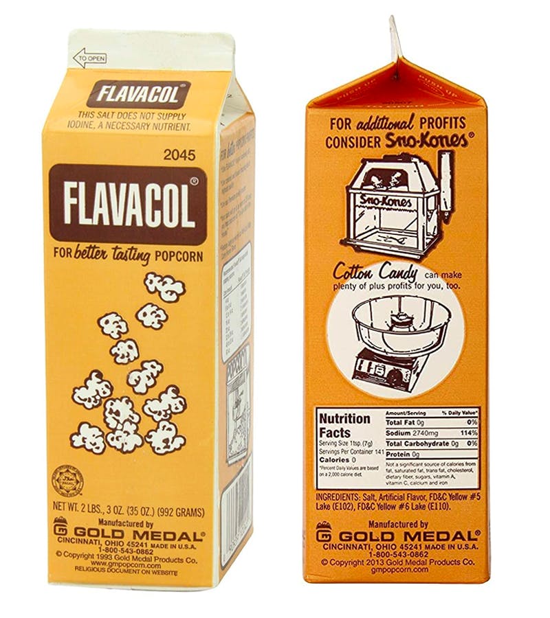 A front and side view of a box of Flavacol Popcorn Season Salt on a white background.