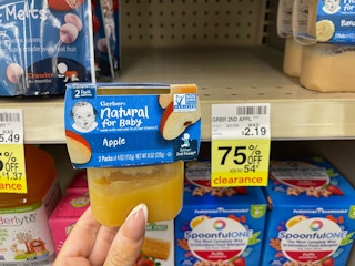 hand holding gerber baby food in front of 75% off tag at CVS
