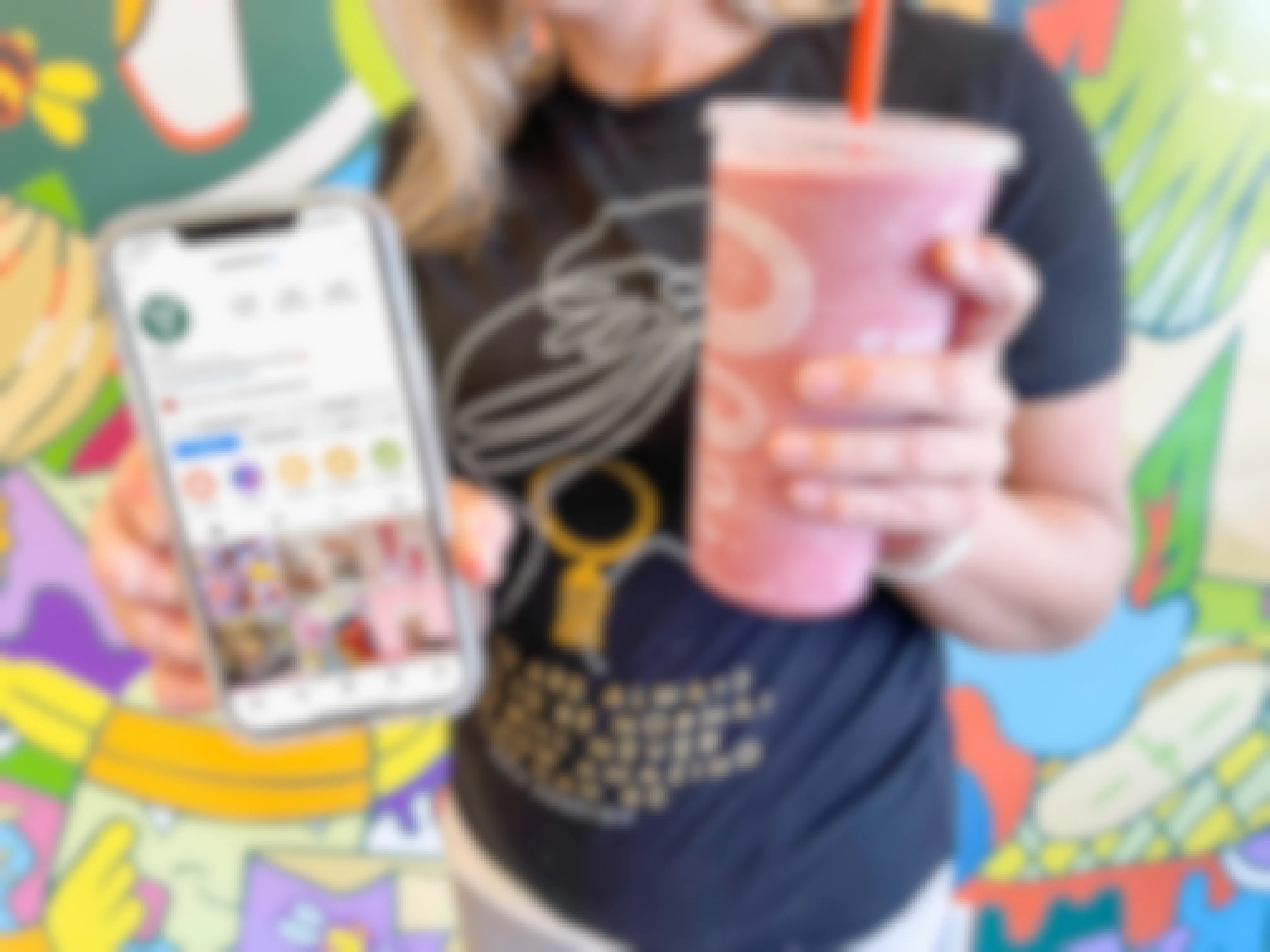 woman holding cell phone with jamba juice cell phone and smoothie in other hand 