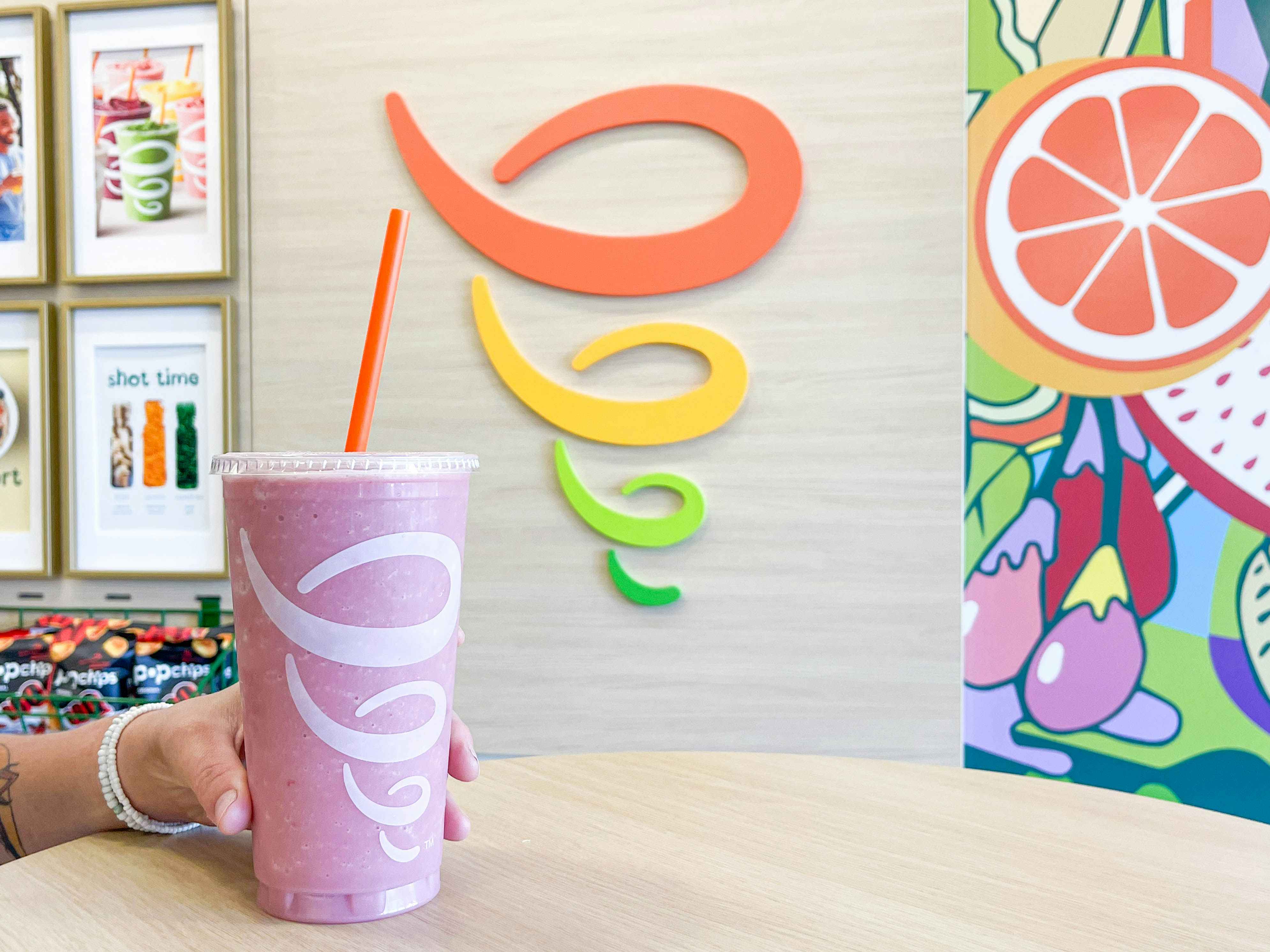 large smoothie in table being held 