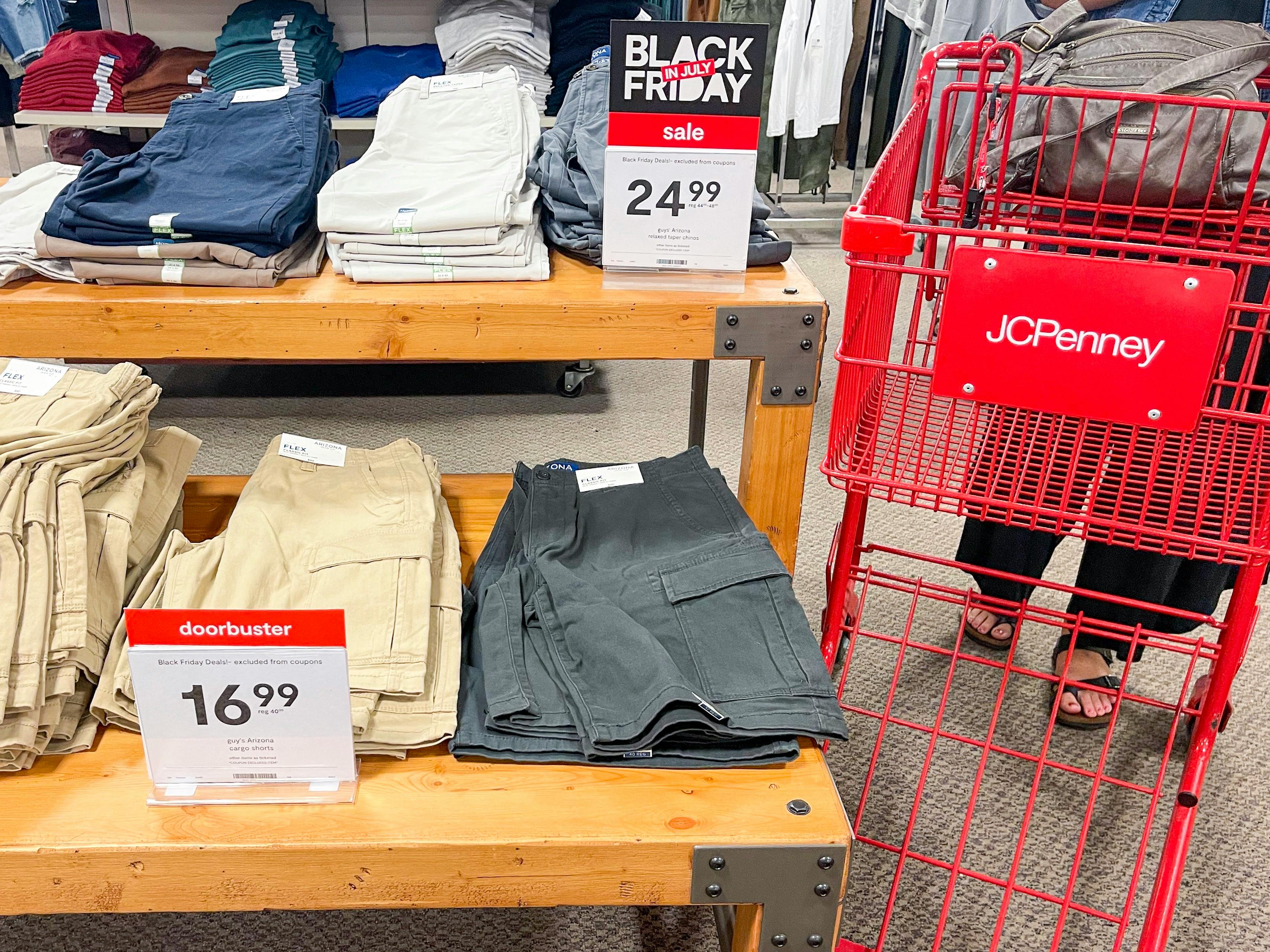jcpenney cart next to mens cargo shorts on shelfs with doorbuster sign