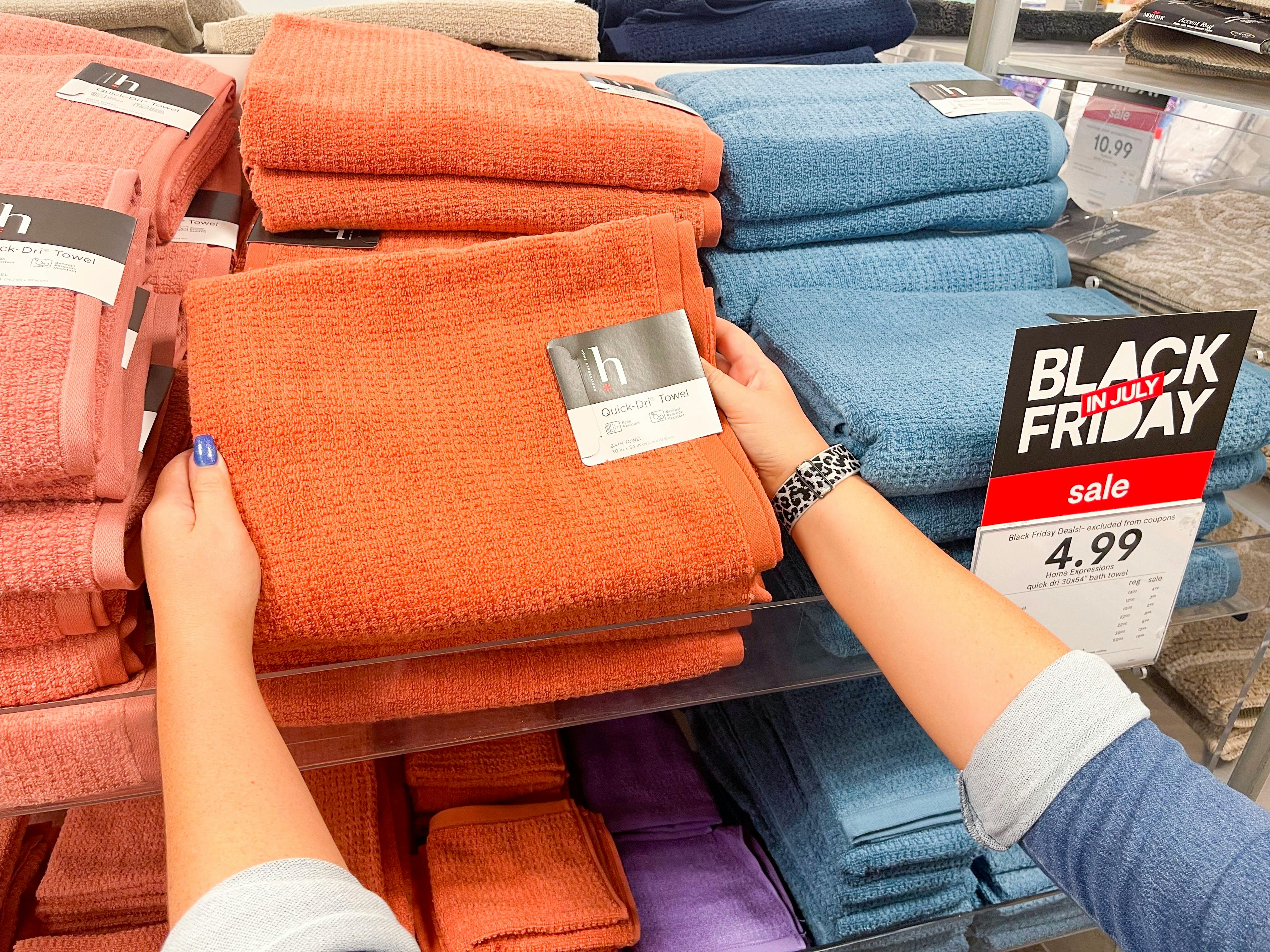 quick dri towel being held on display rack next to black friday sign