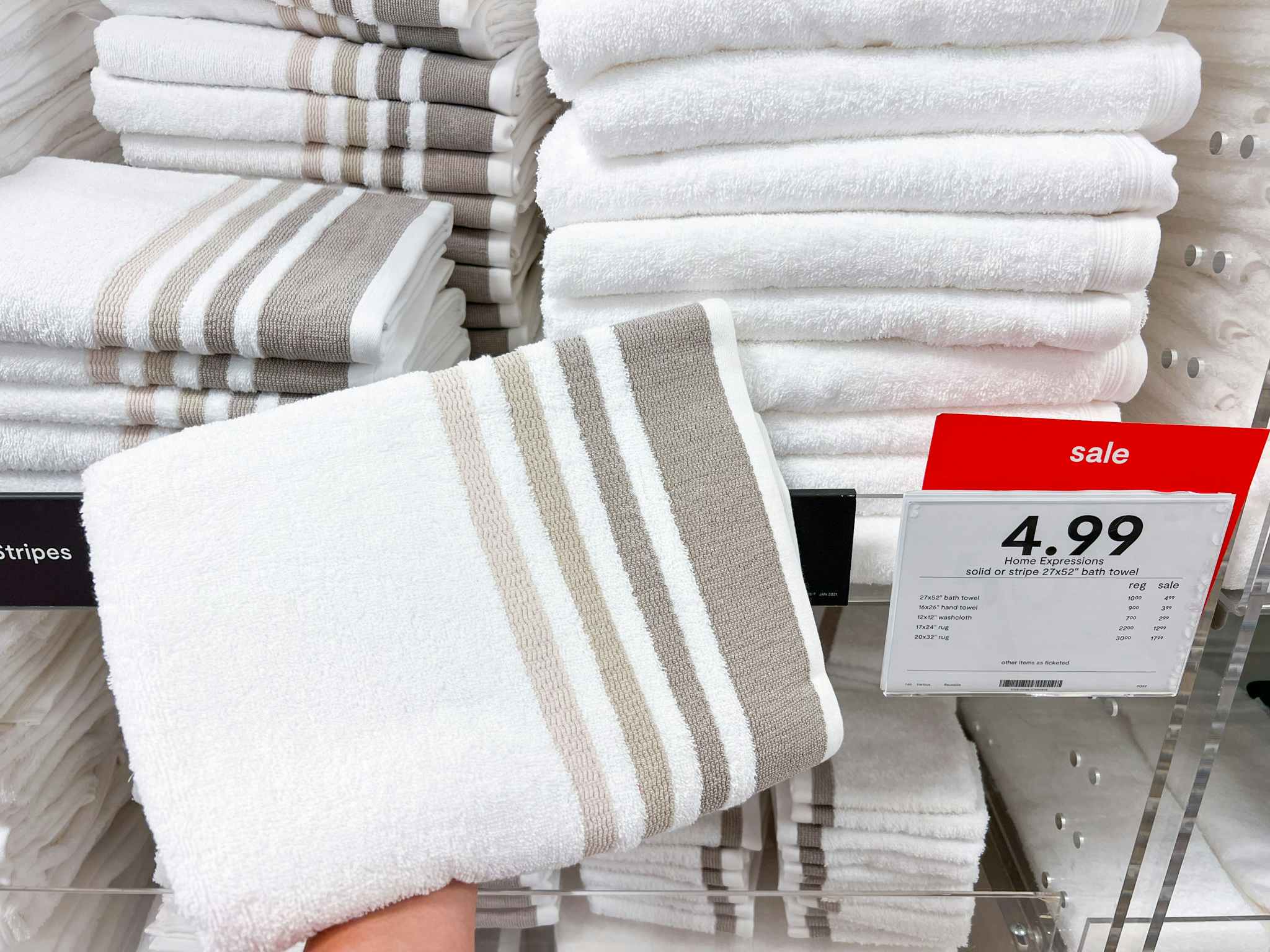 Home Expressions Towels on display next to a sale sign at JCPenney