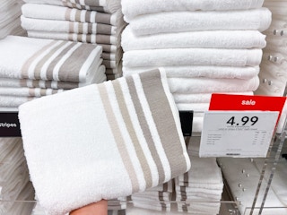 Home Expressions Towels on display next to a sale sign at JCPenney