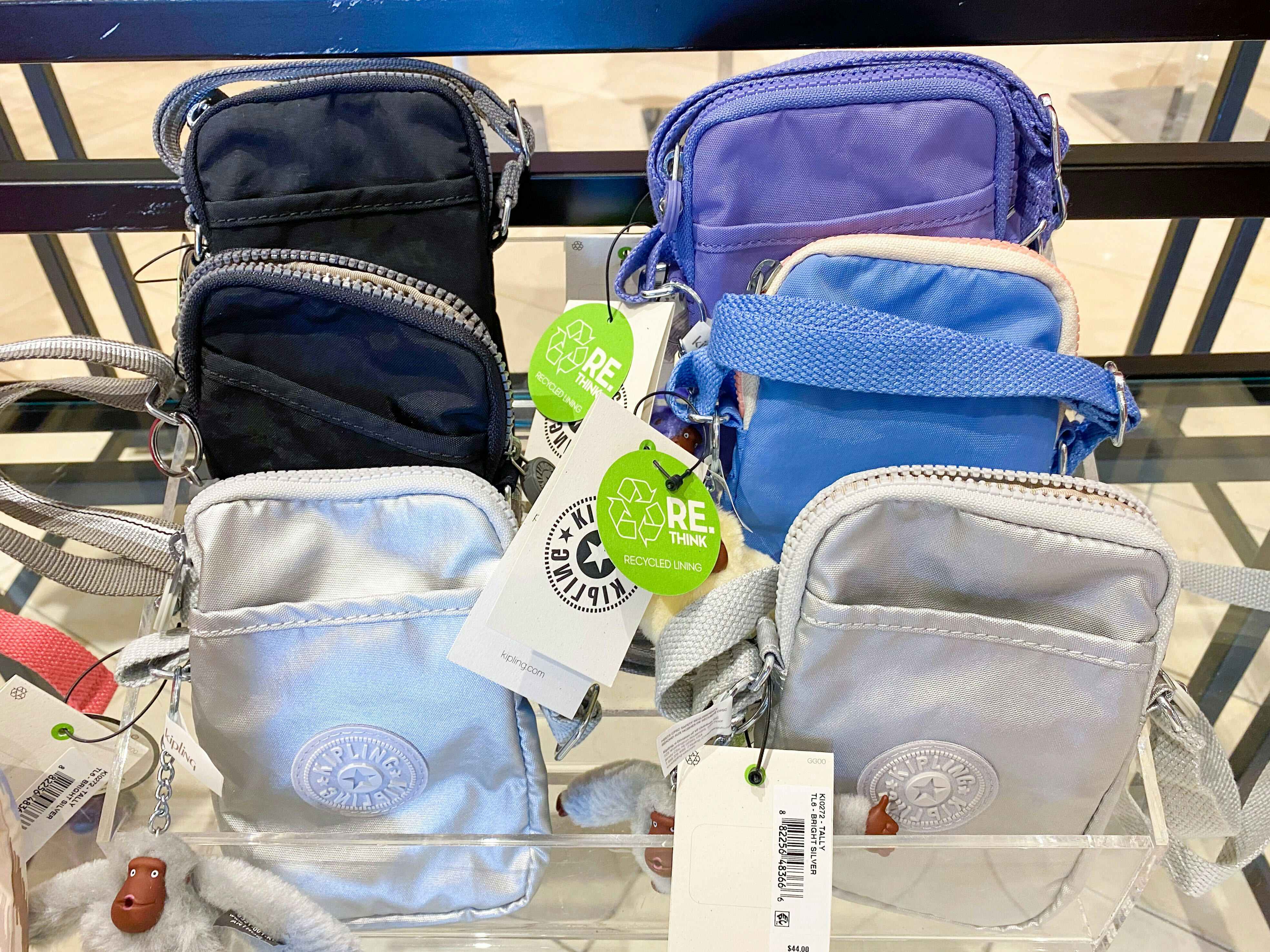 display of various colors of small kipling bags