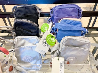 display of various colors of small kipling bags