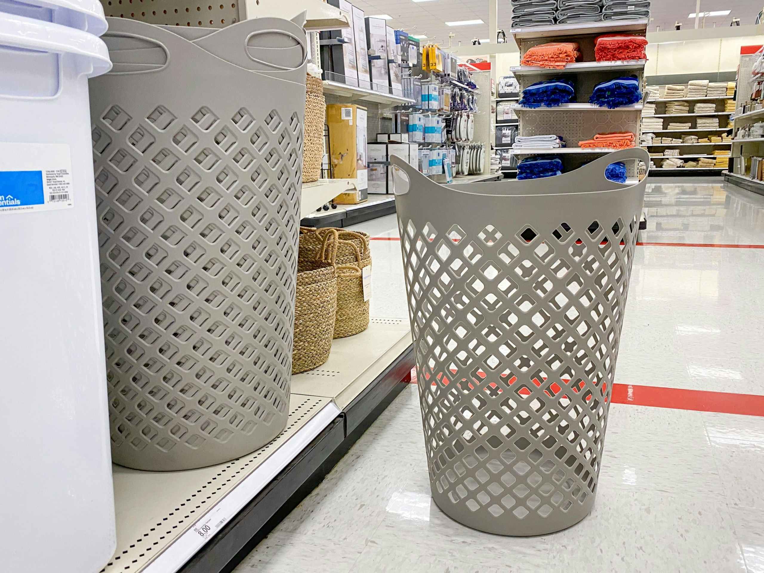 room essentials gray laundry hamper in front of hampers on a target shelf