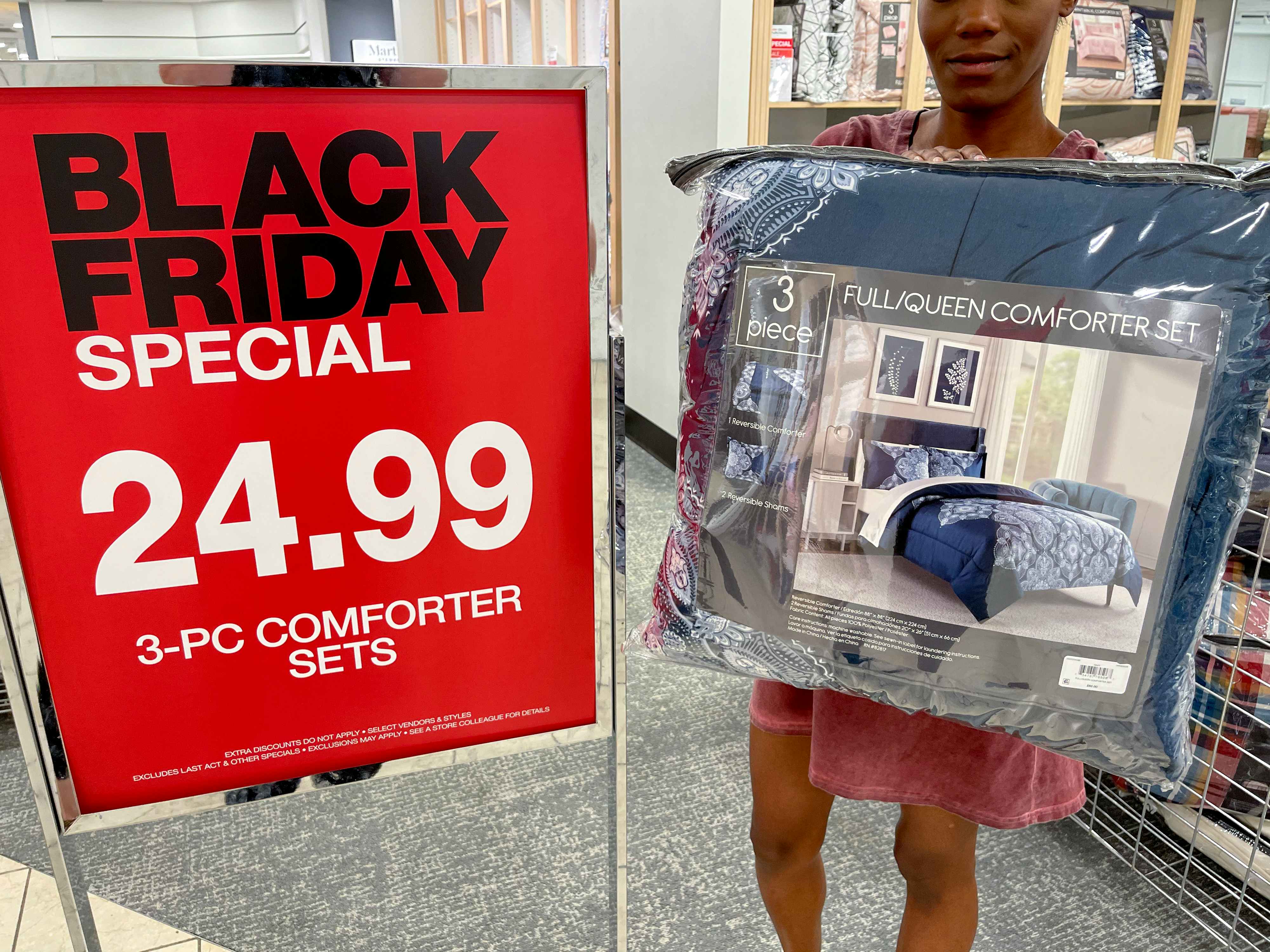 macy bedding being held by black friday signage 