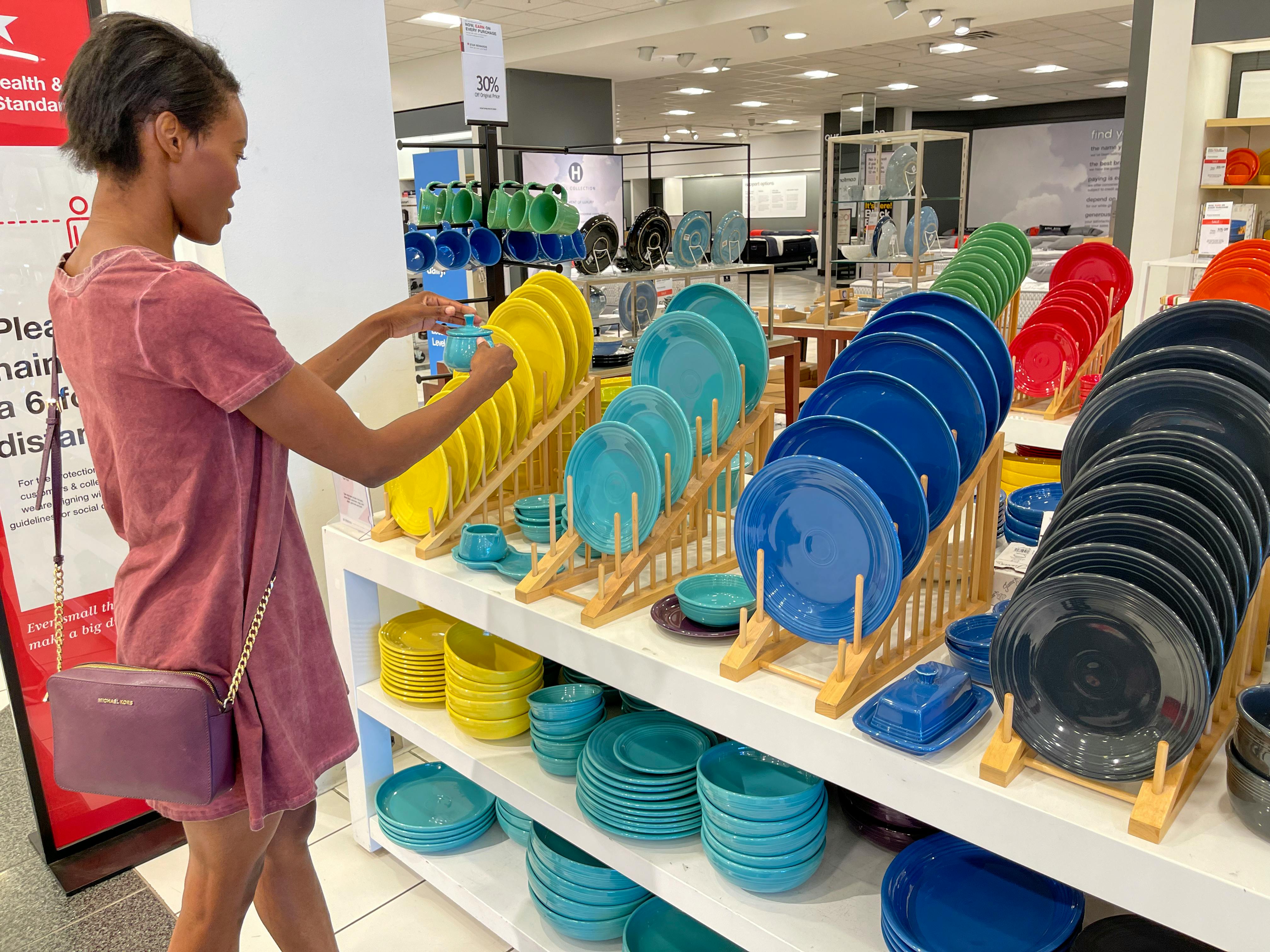 A person shopping for dishes in Macy's