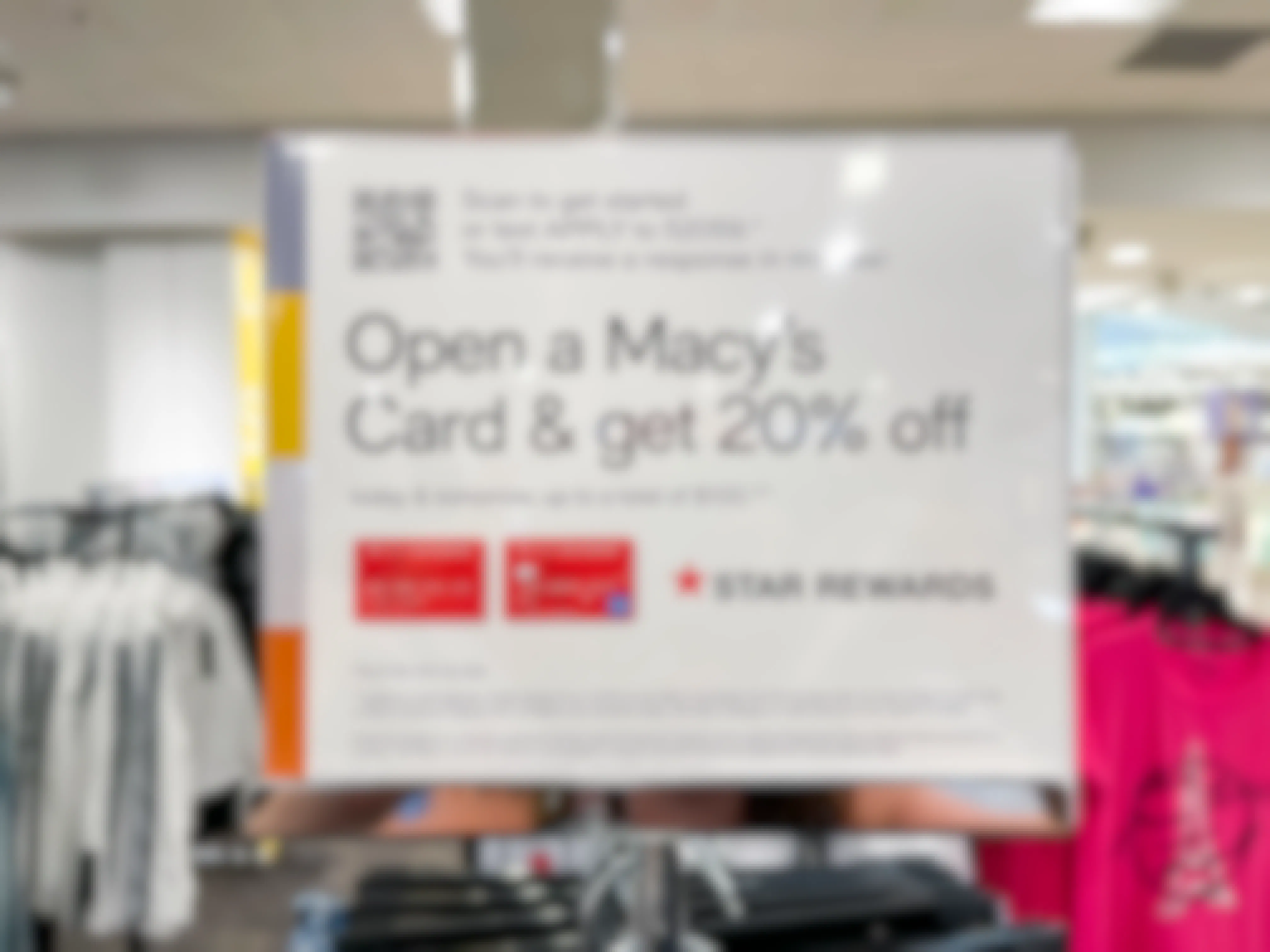 a sign at a Macy's store promoting 20% off when you sign up for a Macy's Credit Card