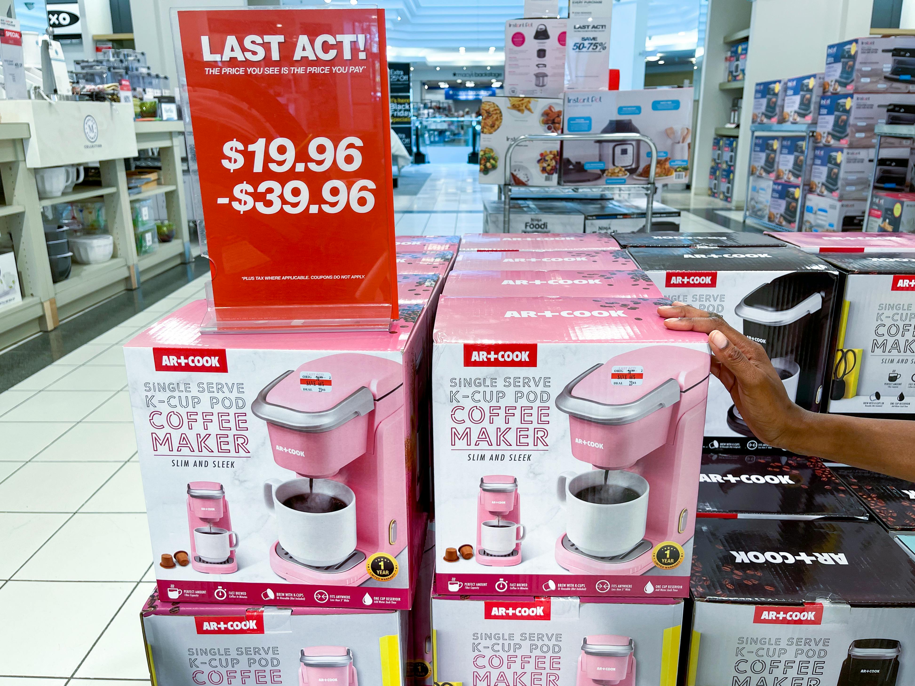 coffee makers stacked up at macy's with a sign that says LAST ACT!