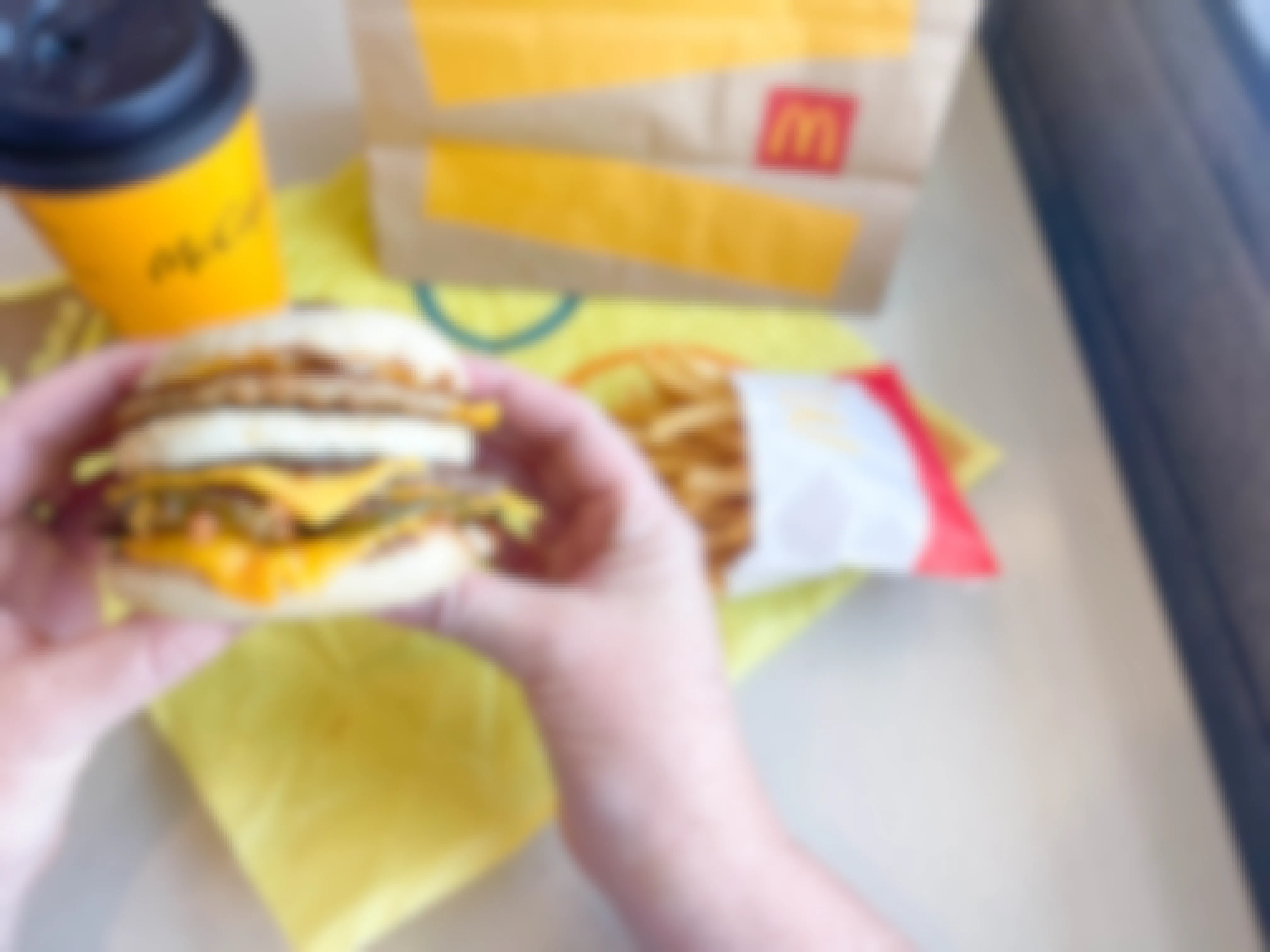 mcdonalds secret menu mcmuffin wand freis on table with mcmuffin being held
