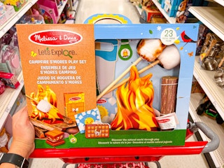 A Melissa & Doug Let's Explore Campfire Smores Play Set in a Target shopping cart