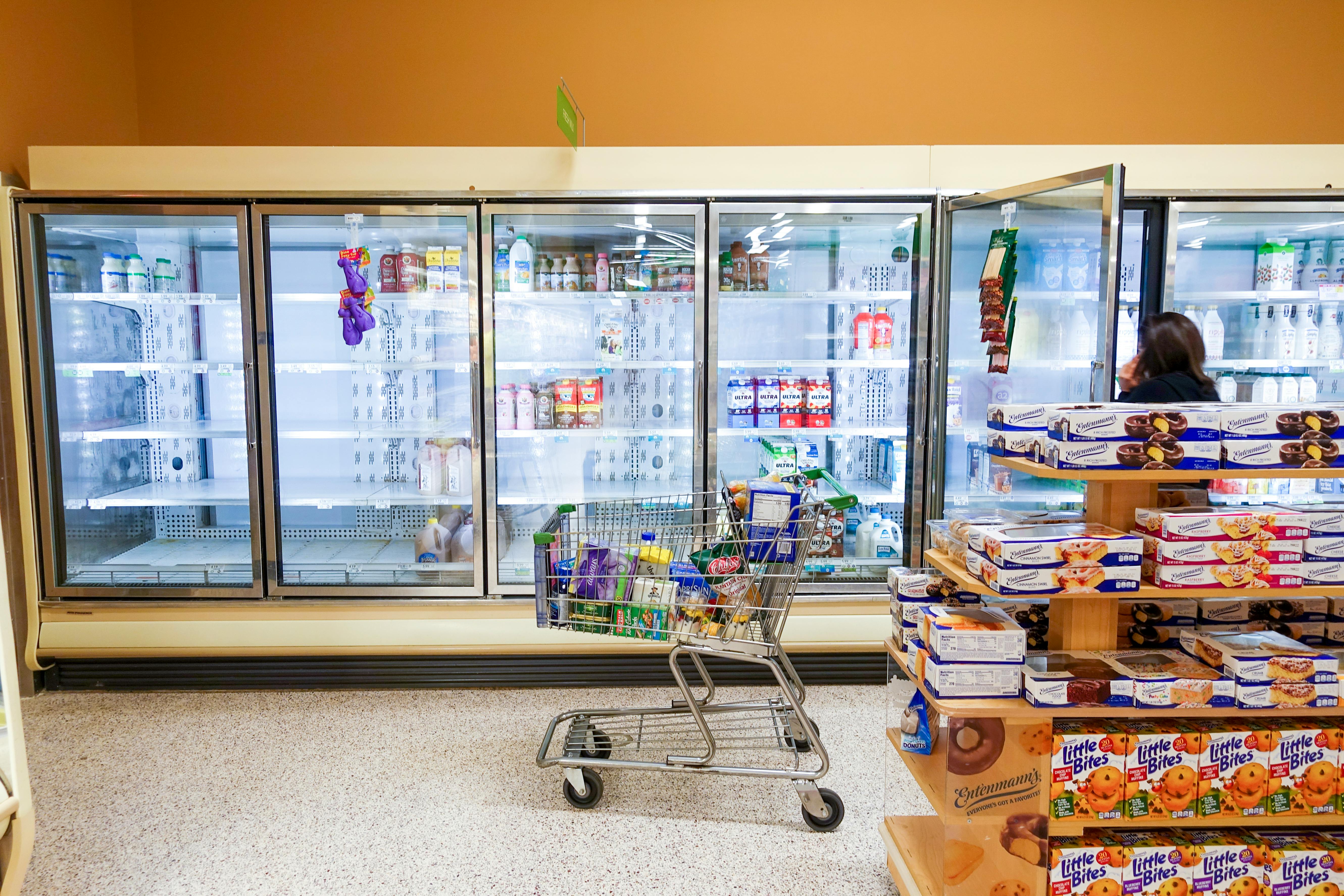 An empty dairy case at a grocery store, showing a milk shortage.