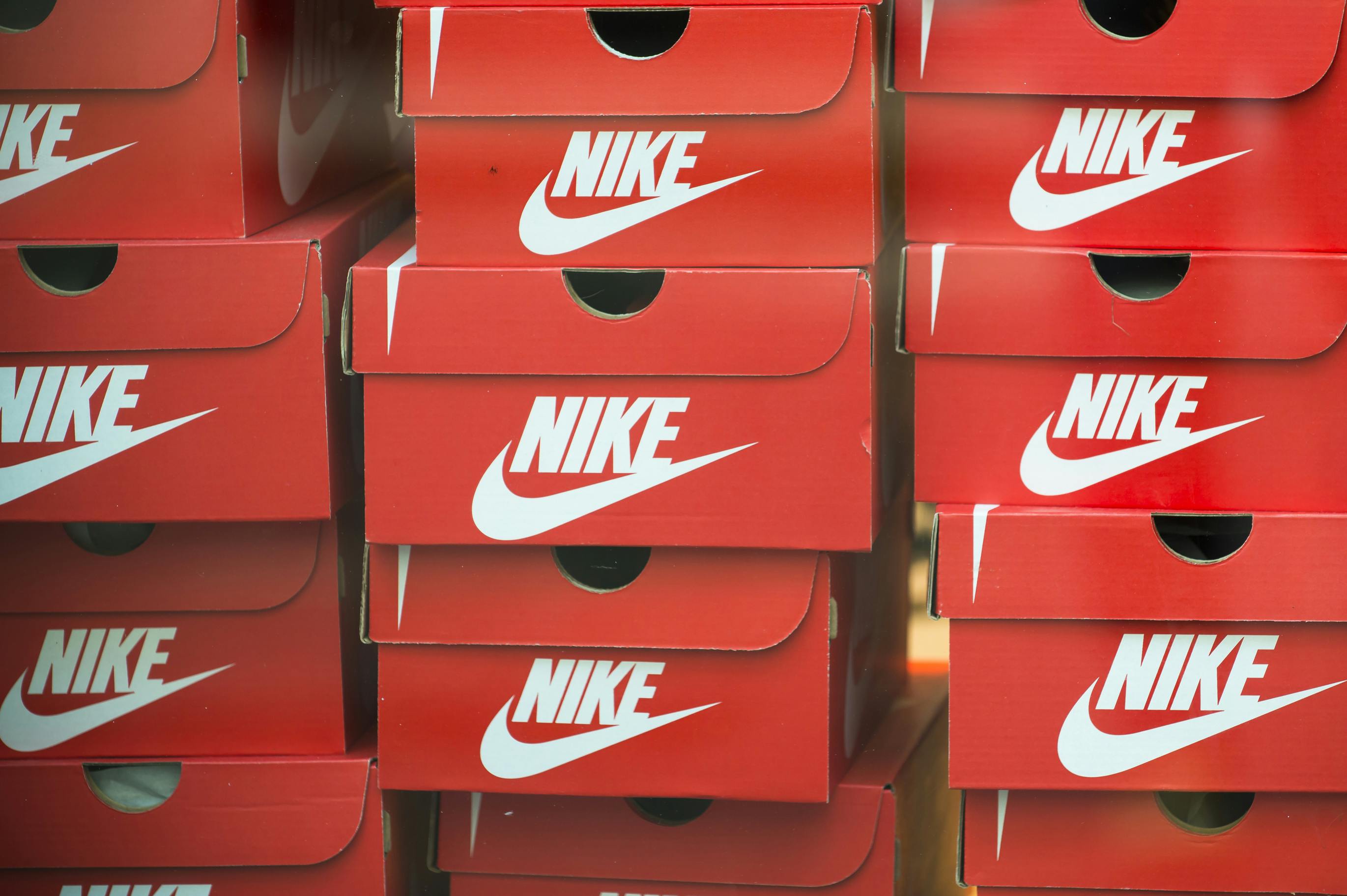 Three stacks of Nike shoeboxes in a store.