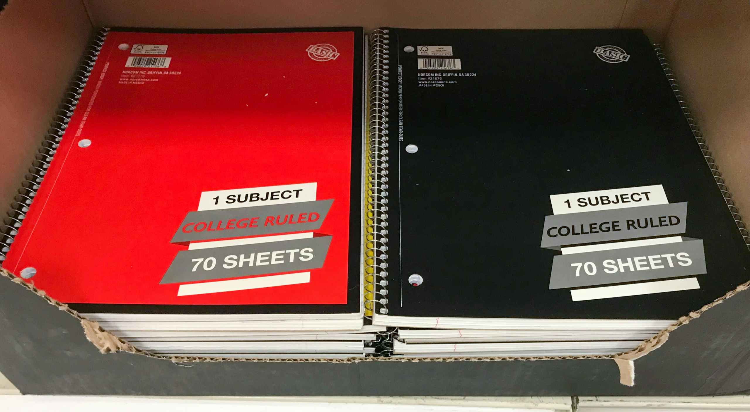two piles of one-subject notebooks at Target on store shelf