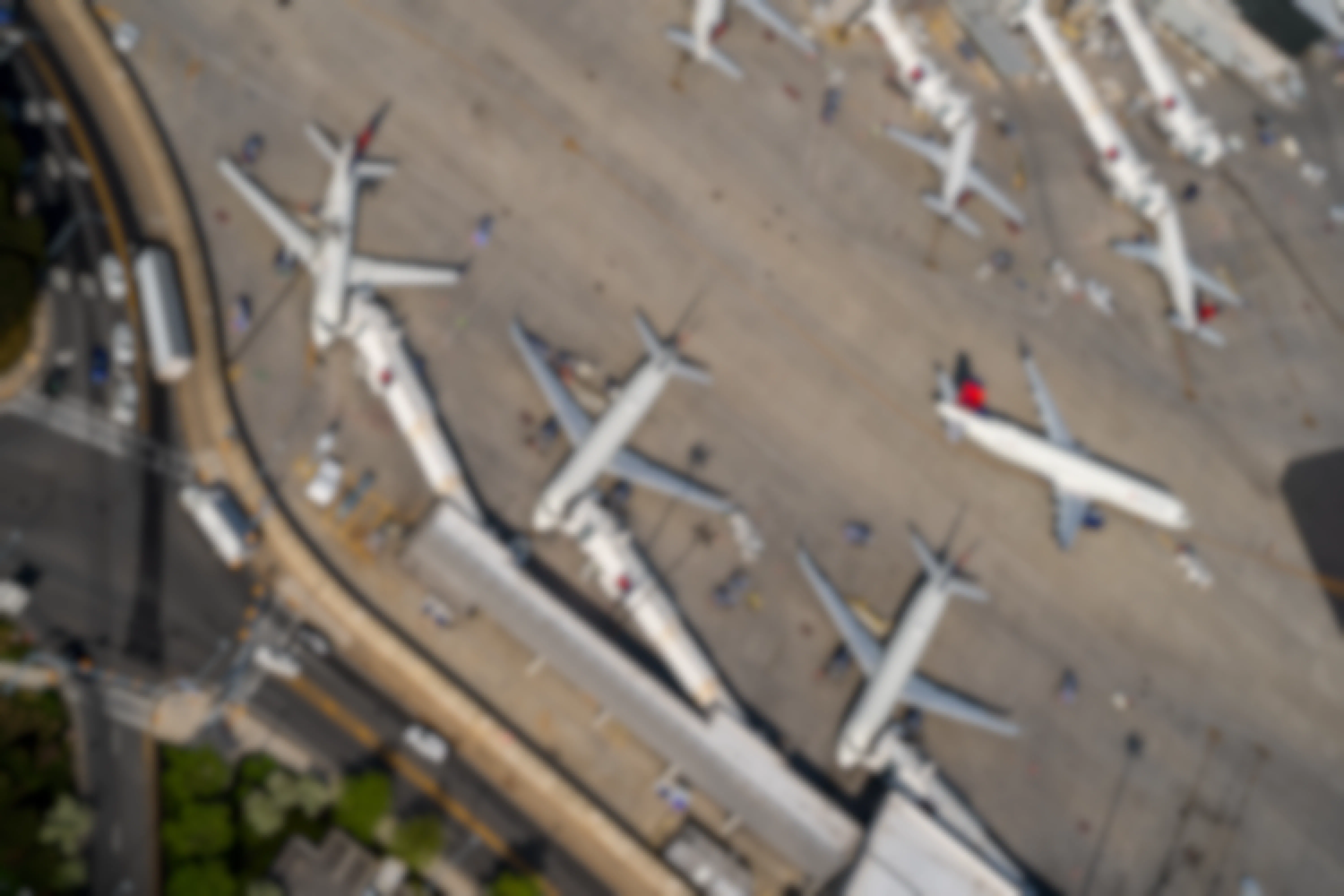 An aerial shot of airport gates, with lots of planes parked.