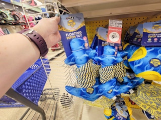 hand holding a banana boat floating anchor dog toy