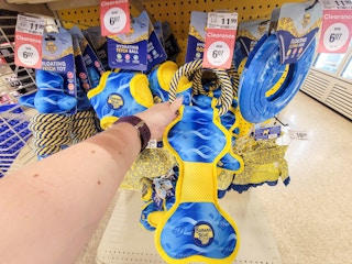 hand holding a banana boat rope dog toy