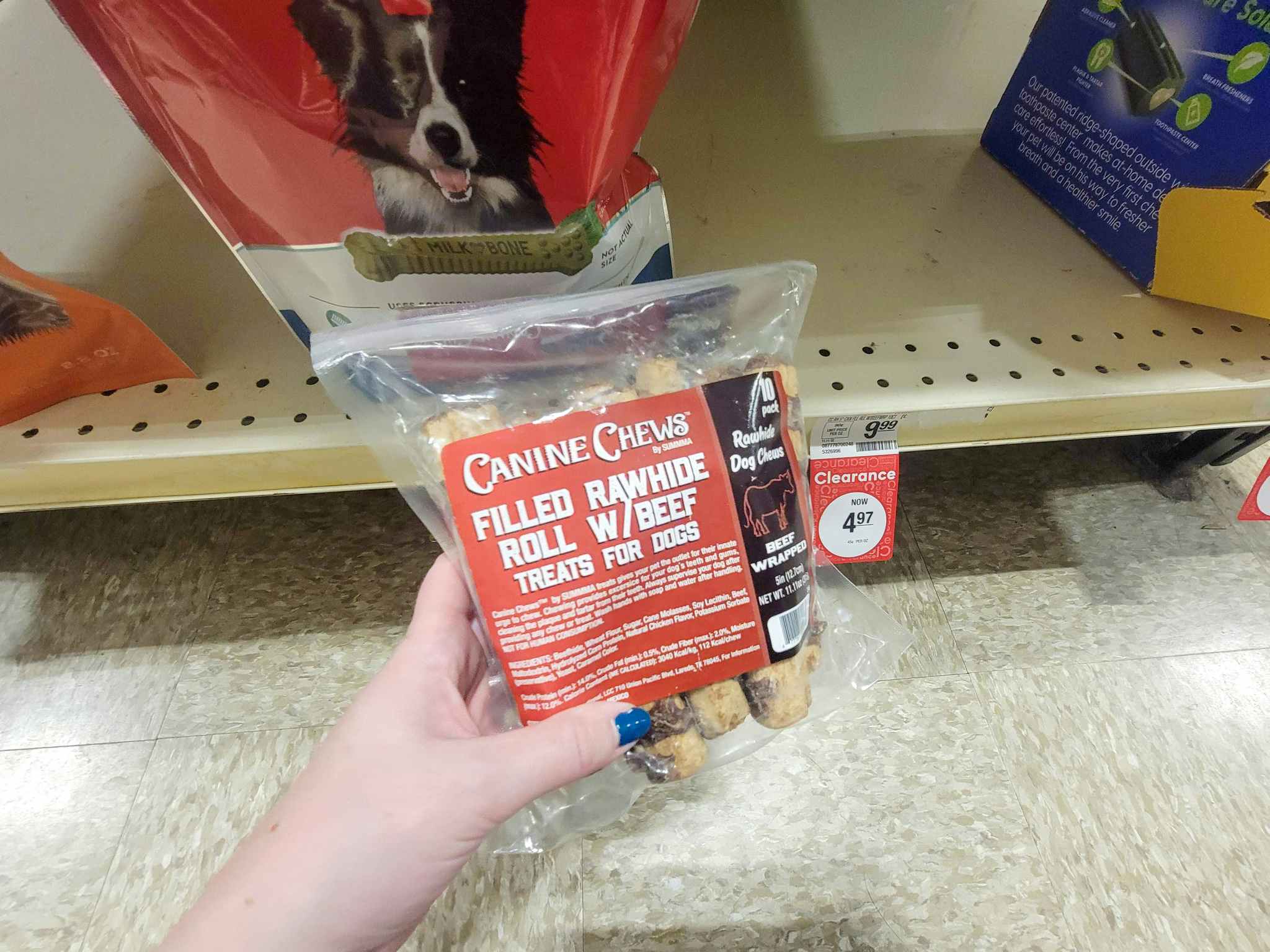 hand holding a bag of dog chews