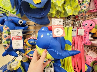 hand holding a whale dog toy