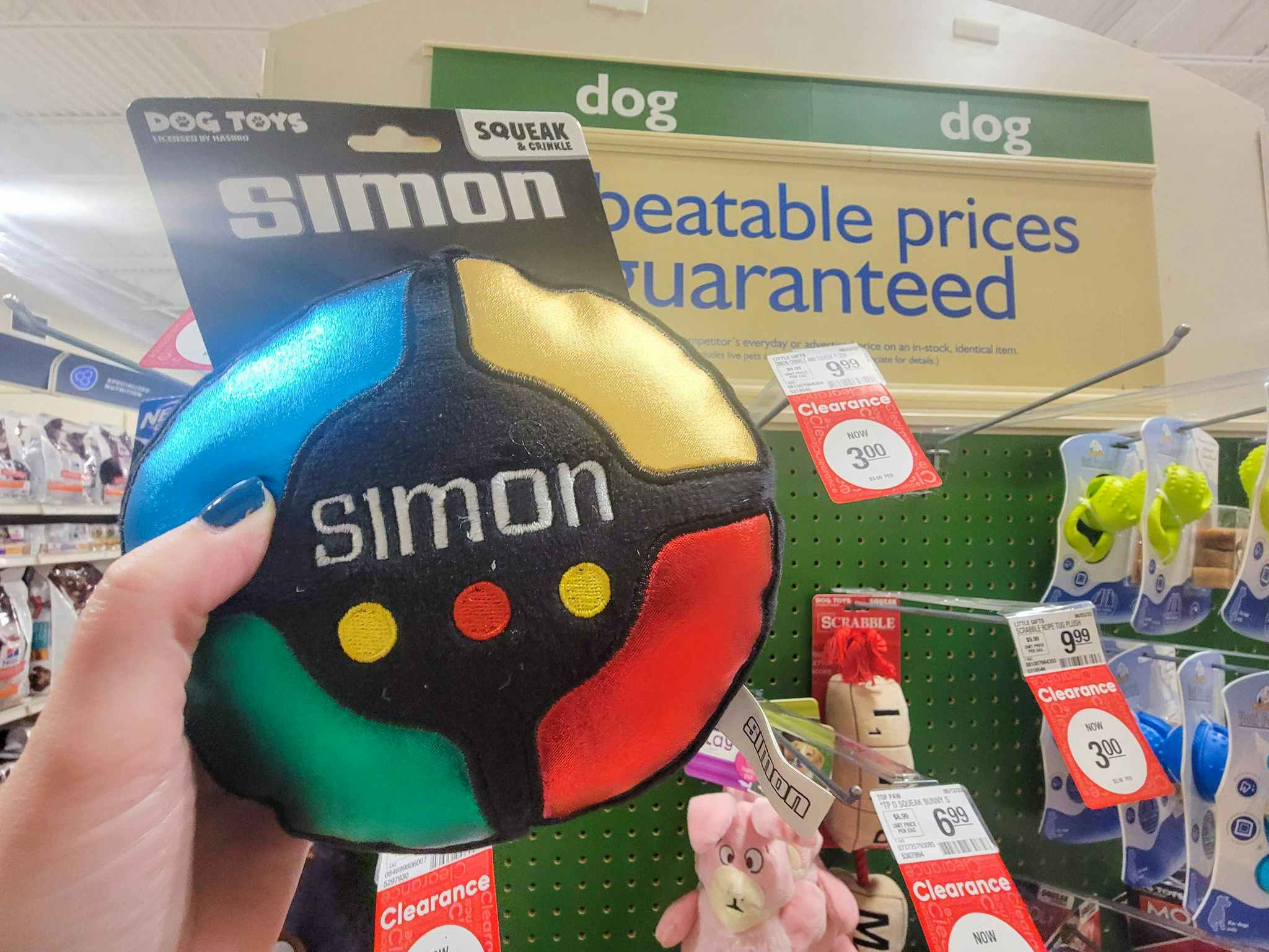 hand holding a simon game dog toy