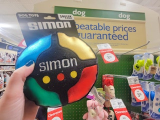 hand holding a simon game dog toy