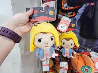 hand holding a plush eleven character from stranger things dog toy