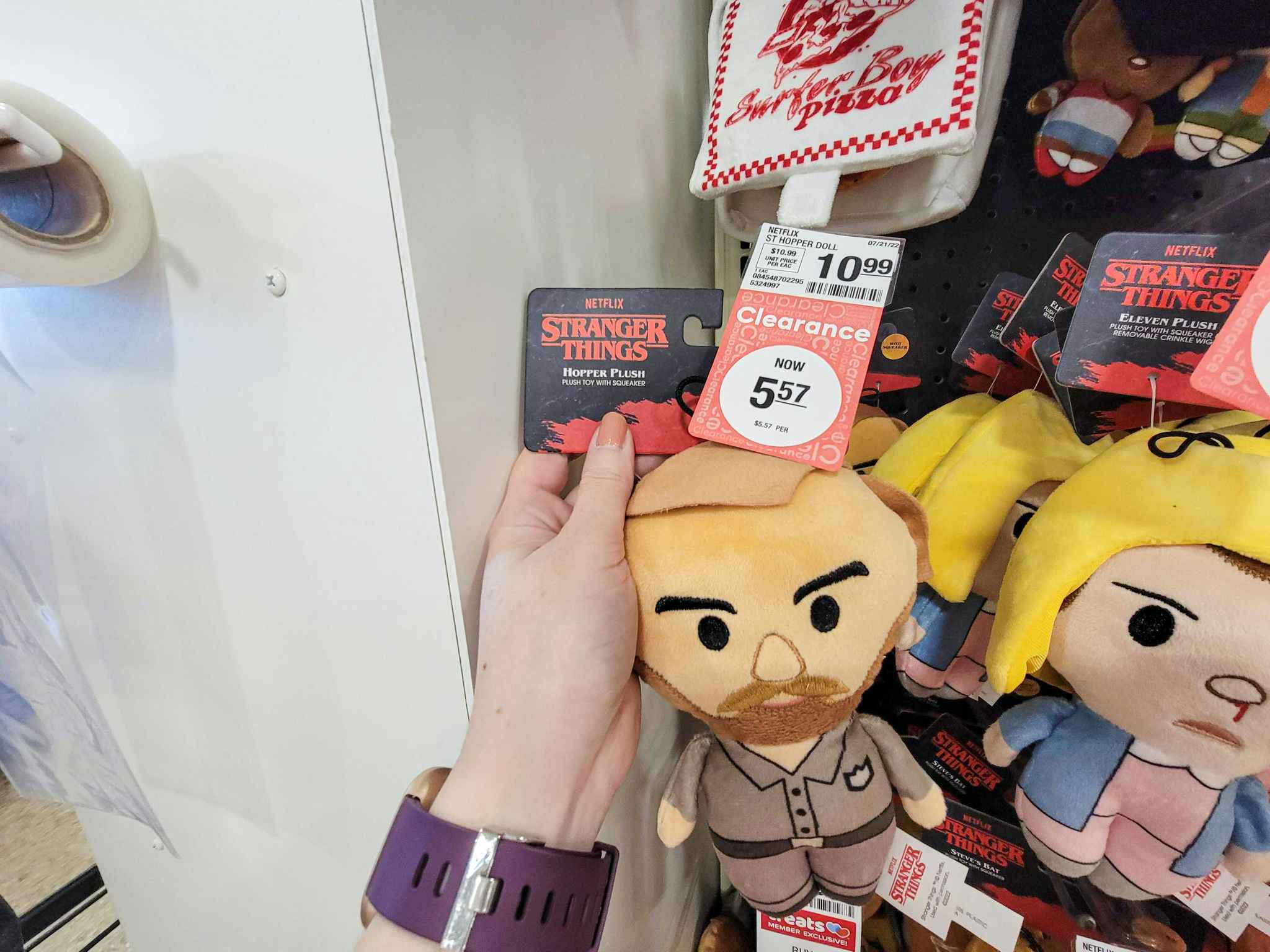hand holding a plush hopper from stranger things dog toy