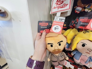 hand holding a plush hopper from stranger things dog toy