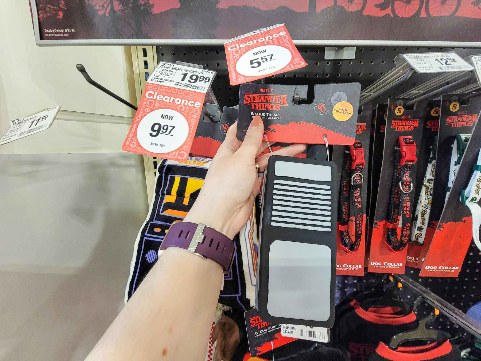 hand holding a stranger things walkie talkie dog toy