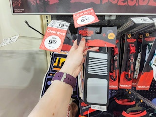 hand holding a stranger things walkie talkie dog toy