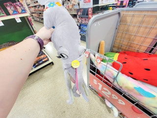 hand holding a xxl squid dog toy