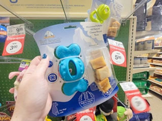 hand holding a yeti poofs dog treat toy