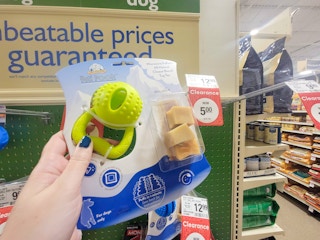 hand holding a yeti poofs dog treat toy