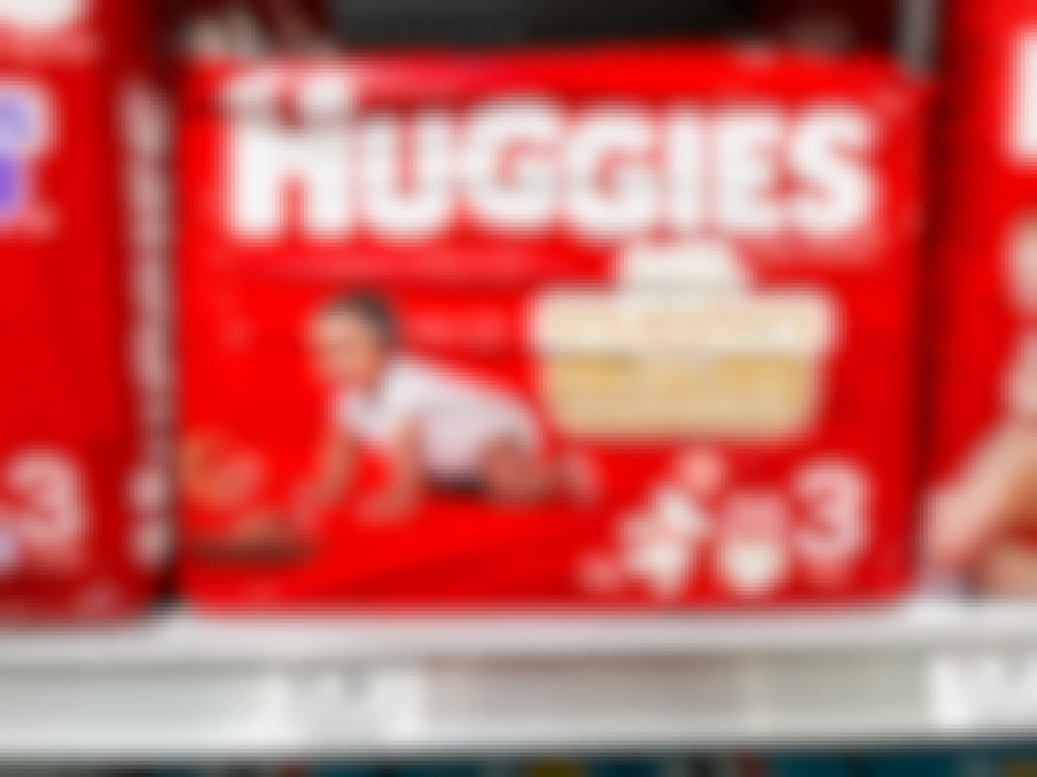 A pack of Huggies Little Snugglers diapers on a store shelf.