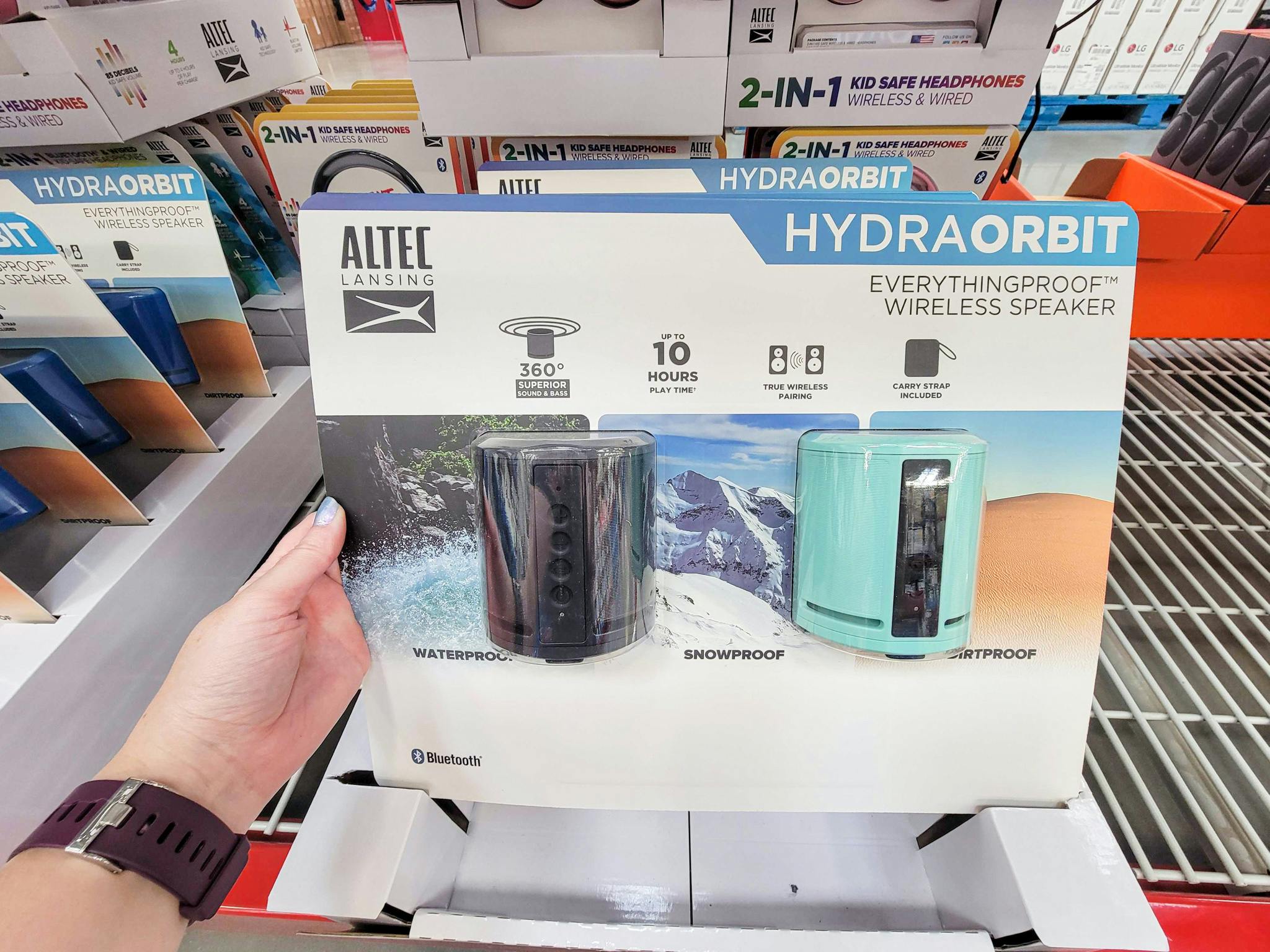hand holding a 2-pack of altec lansing hydraorbit speakers